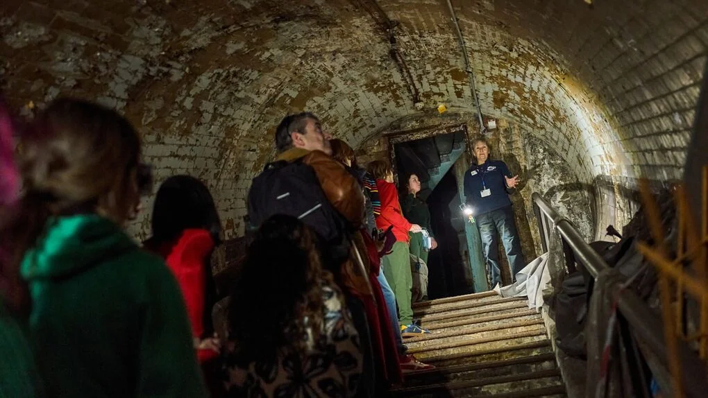 A group of people exploring an underground tunnel