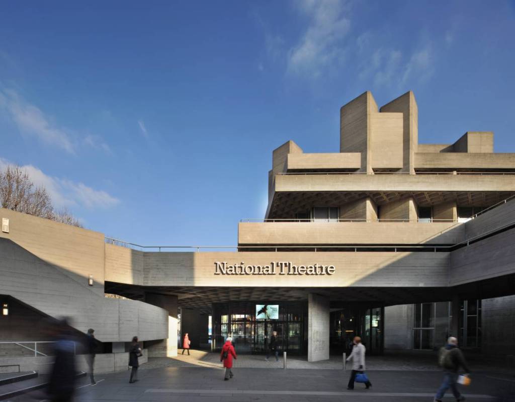 the entrance to the national theatre in london as seen on a beautiful blue sky day