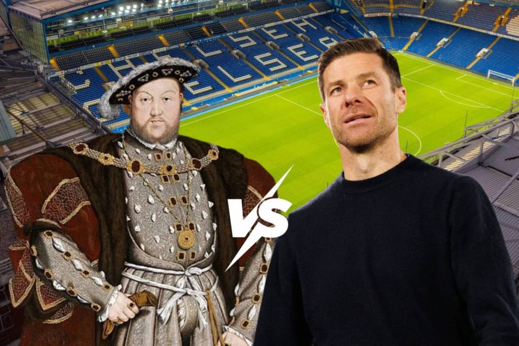A football stadium with blue chairs in the background with an image of Henry VIII on one side wearing a hat and hold chain and tudor clothes and Xabi Alonso on the other side wearing a black jumper with a "VS" motif in between them.