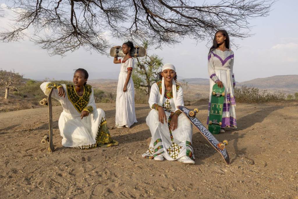 skaters posing in bright white outfits near a skate park in ethiopia