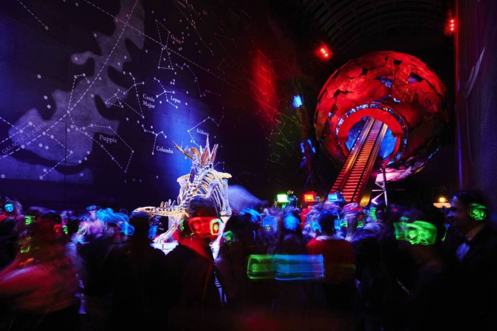 a silent disco party with loads of neon lights glowing in the dark 