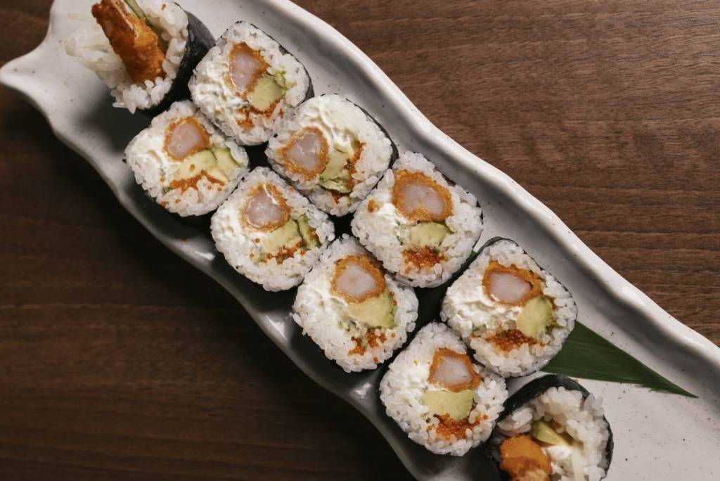 a close up of dragon maki sushi served on a rectangular plate at Bamboo Mat Canary Wharf