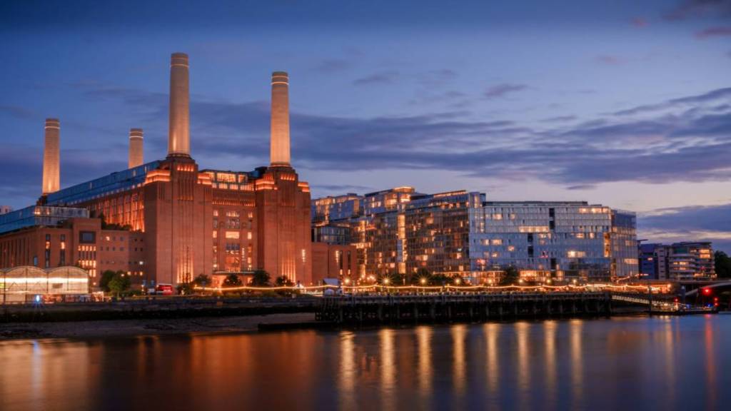 a long shot of Battersea Power Station in the evening with the Thames in the foreground
