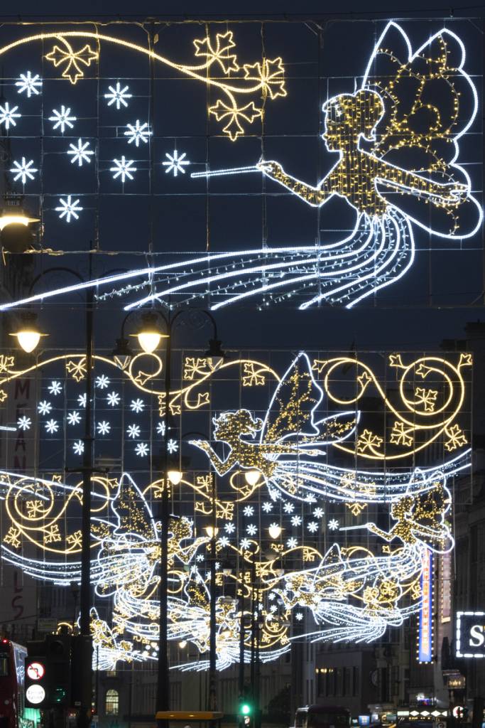 fairy themed Christmas lights glowing over a london street at night