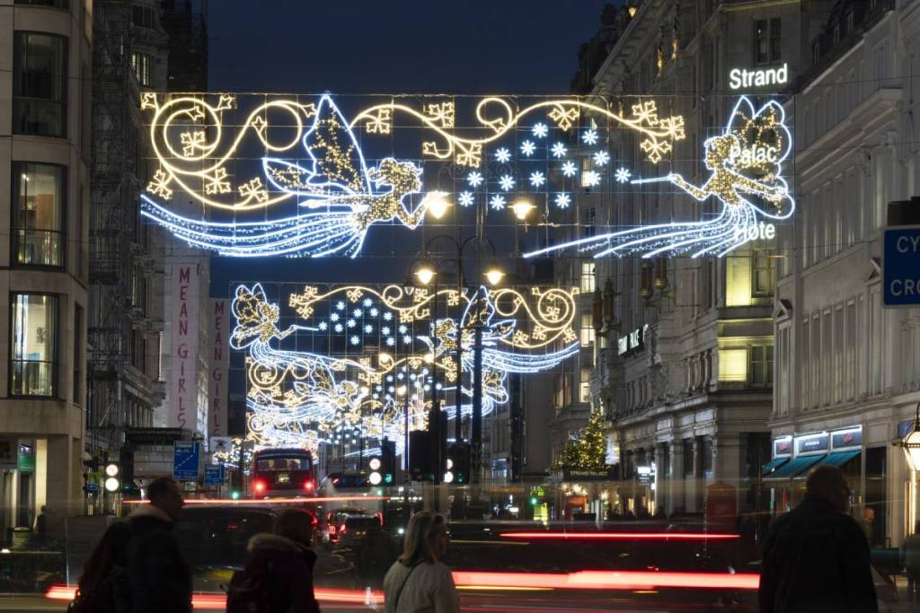 fairy themed Christmas lights glowing over a london street at night
