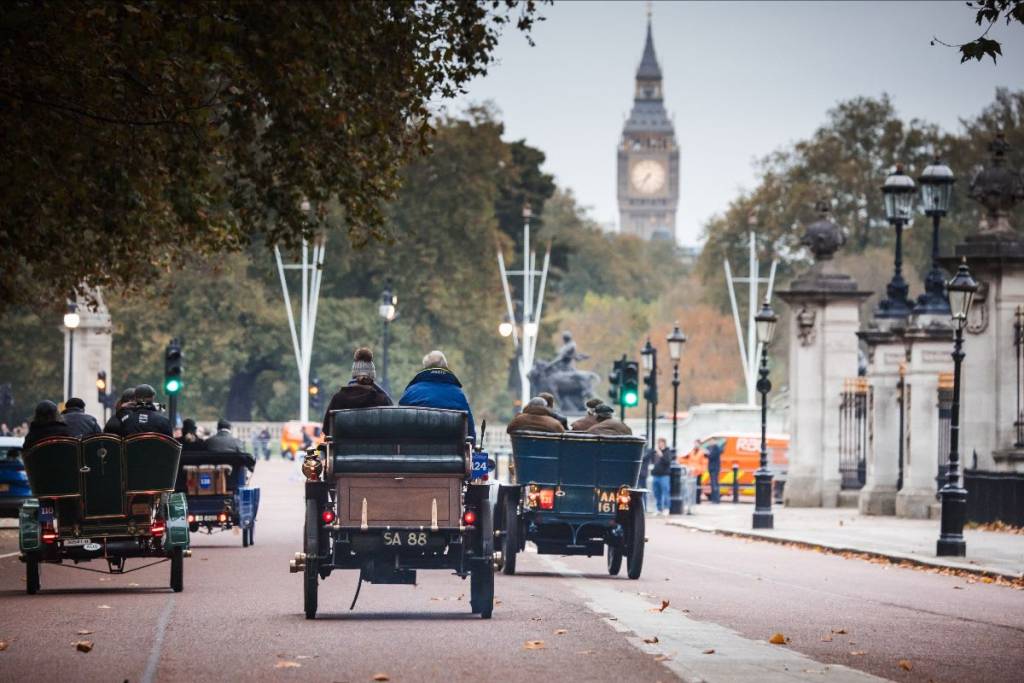 Several veteran cars driving through central London