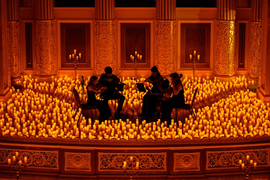 string quartet perform among candles at St. George's Hall