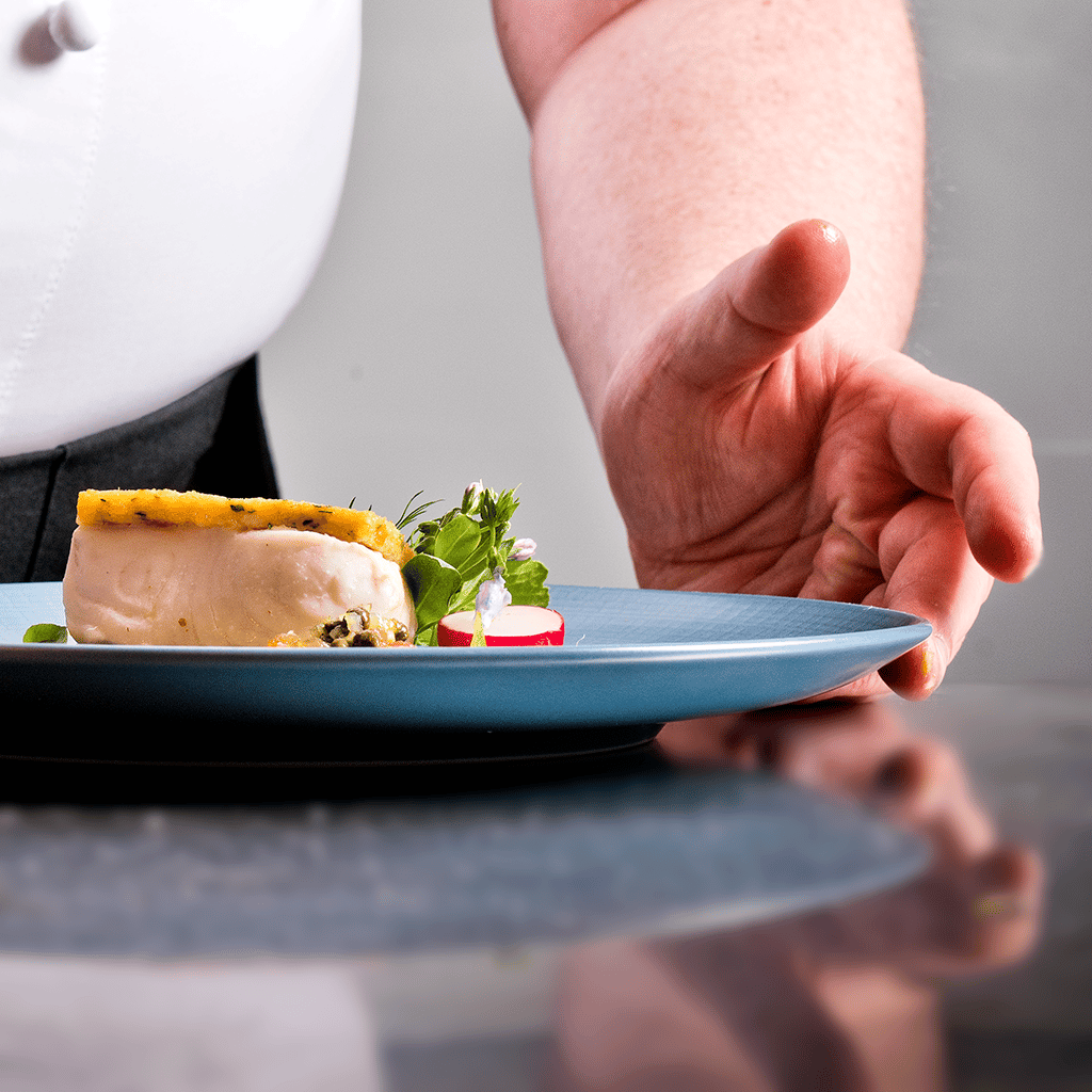 A chef presents some roasted fish: a dish on the Valentine's Day menu at The Art School.