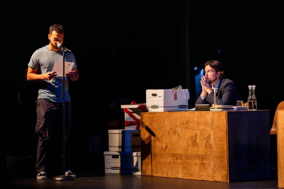 A witness testifying on stage 