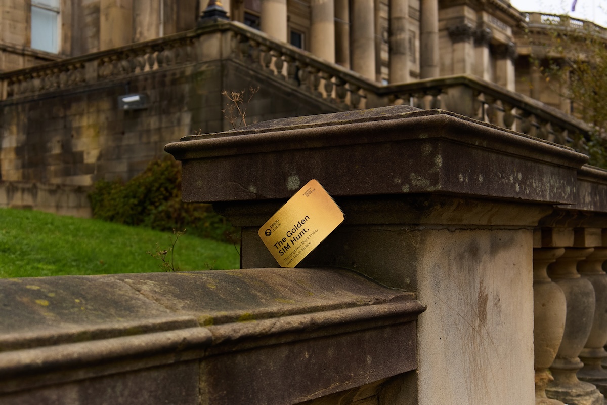a tesco mobile golden sim card hidden by an old stone building in liverpool