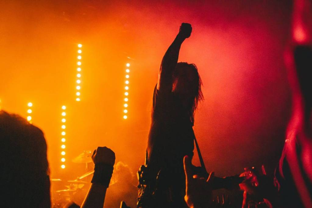 A crowded dance floor, with arms pumping in the air