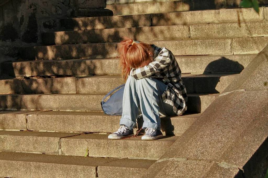 mujer llorando en las escaleras