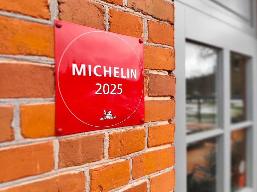 Michelin 2025 placard on a brick wall.