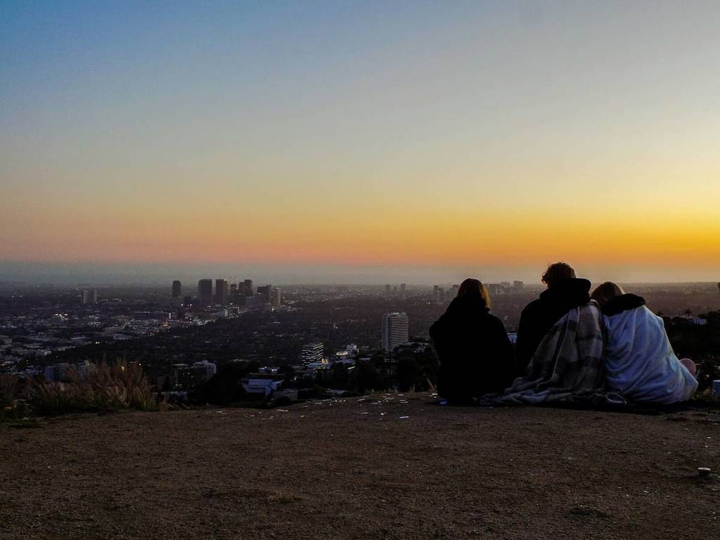 People watch the sunset over LA