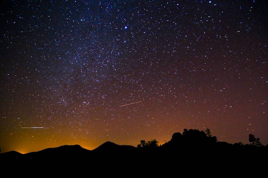 Pinnacles National Park is silhouetted against the night sky