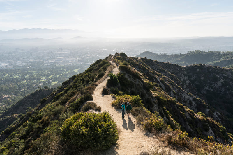 People hike on a trail in Griffith Park