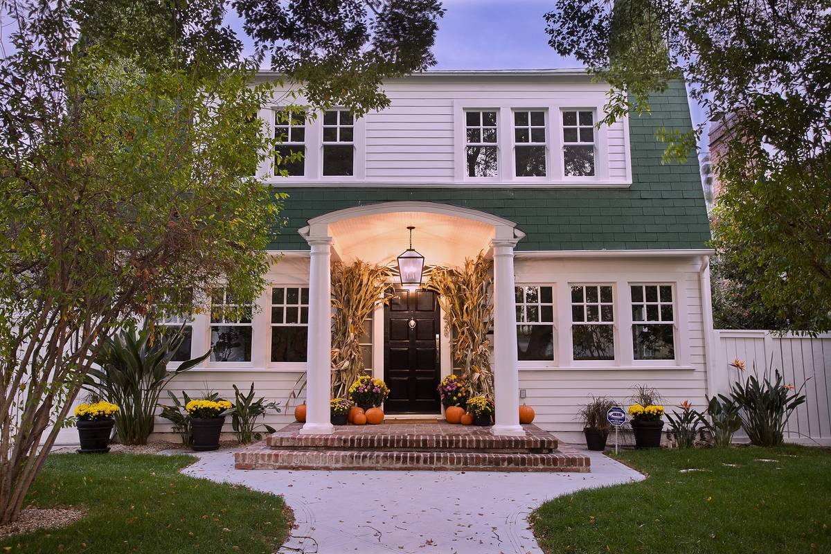 A two-story white colonial-style house with green shutters, famously known as the filming location for Nancy Thompson’s home from A Nightmare on Elm Street.