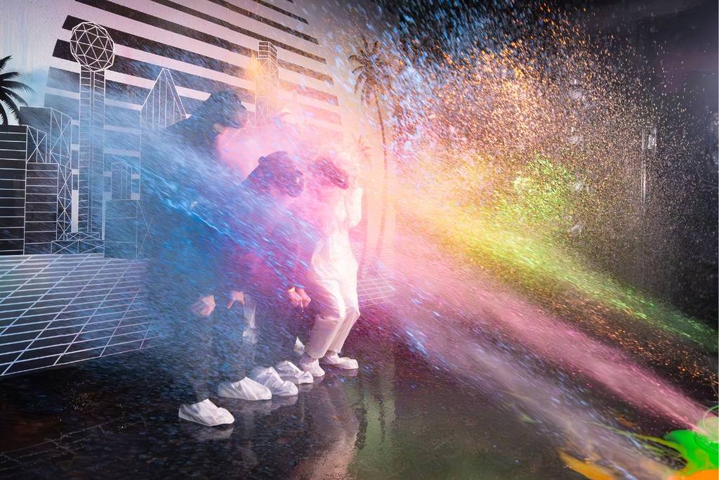Group getting splatted by paint at Glow or Go immersive group experience.