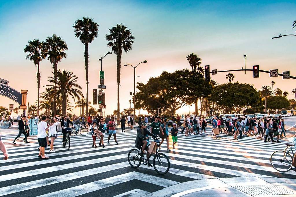 Crowd walking the crosswalk outside Santa Monica Pier.