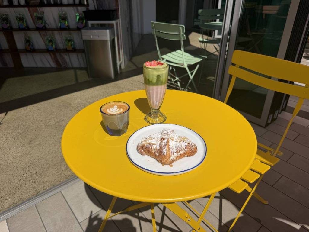 Coffee, matcha drink, and pastry on one of Couplet Coffee¡s outdoor sears