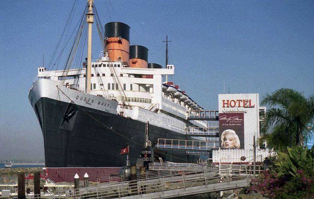 The Queen Mary Ship in Long Beach with a sign that says 'hotel'.