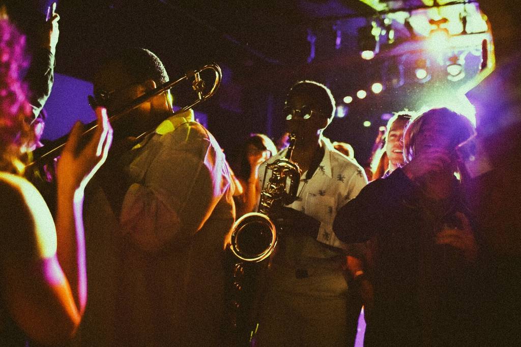 Guests and performers play music and dance at Brassroots