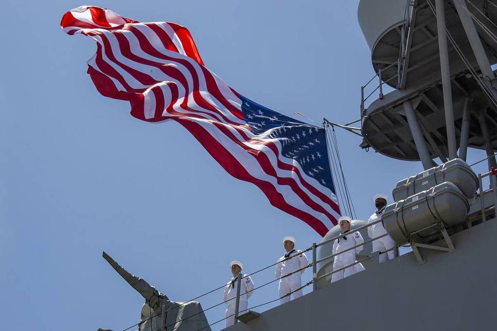 Navy soldiers on a ship with American flag at LA Fleet Week.