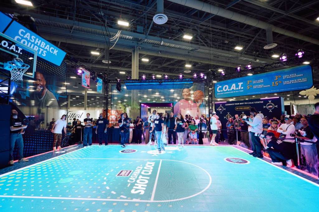 A person shooting a basket ball on the Complexcon court.