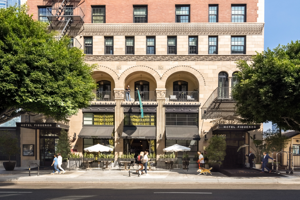 In 1926, LA’s Hotel Figueroa opened as a groundbreaking safe haven for female travelers; exactly 100 years later, the historic landmark is serving spooky seasonal cocktails by its famous coffin-shaped pool