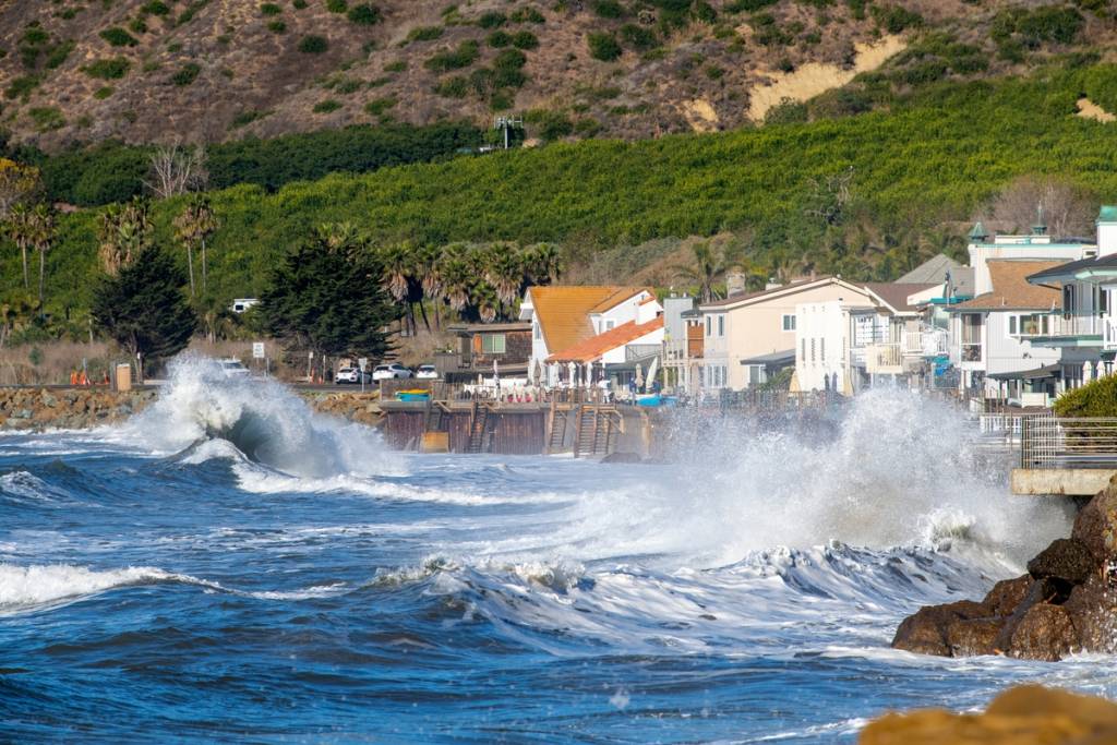 Rare 20-year lunar alignment and warm El Niño swells collide off Southern California, sending historic 8.5-foot tides crashing toward beach communities