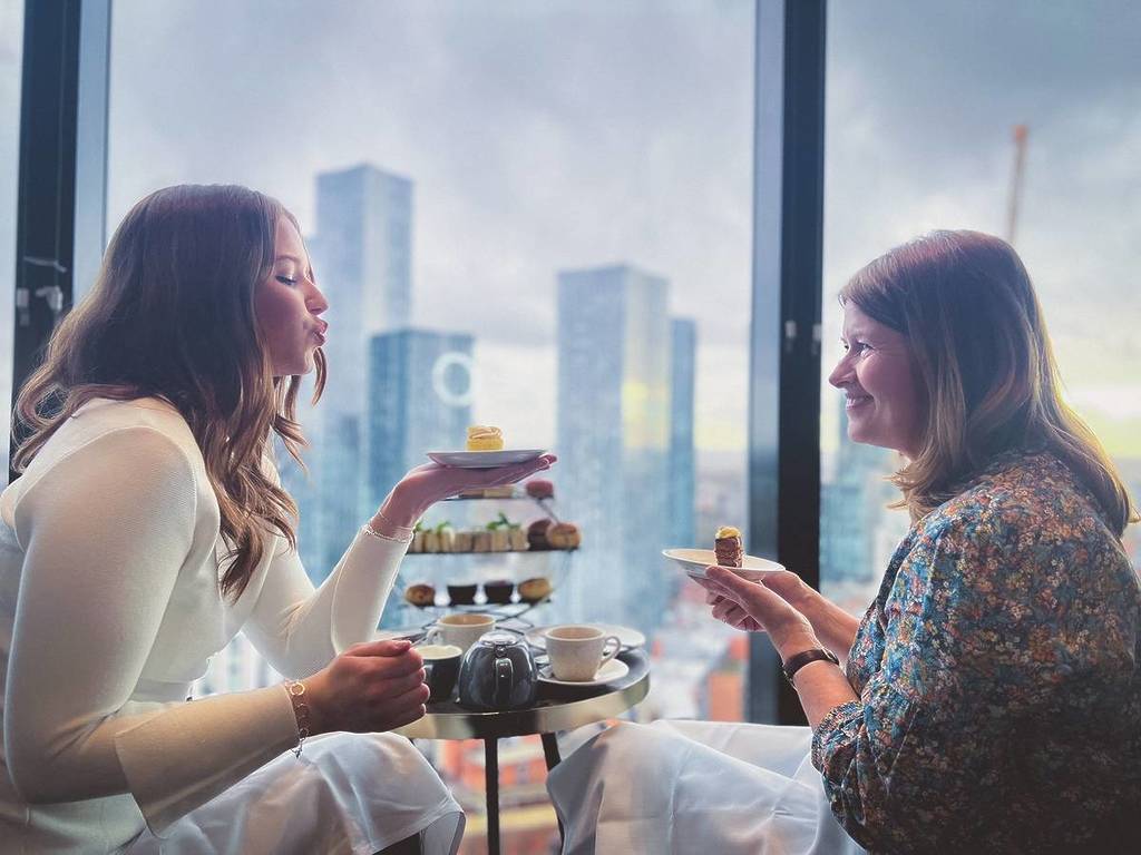 mother and daughter enjoying afternoon tea at cloud 23, manchester deansgate hotel