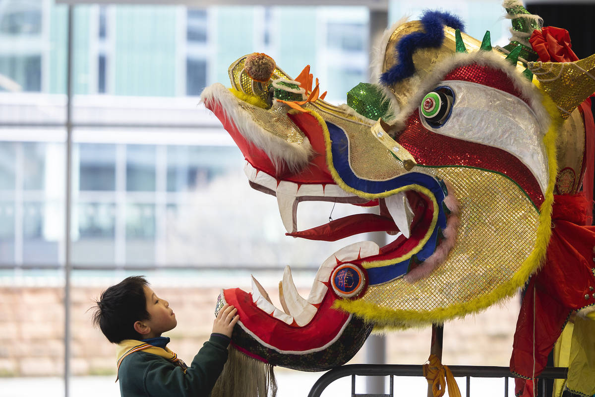 little-boy-looking-up-at-chinese-dragon-as-part-of-lunar-new-year-celebrations-in-manchester