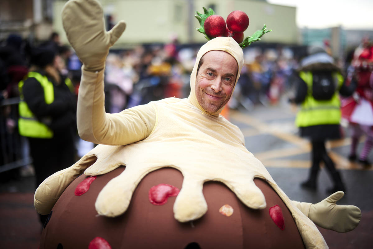 christmas pudding performer as part of manchester christmas parade
