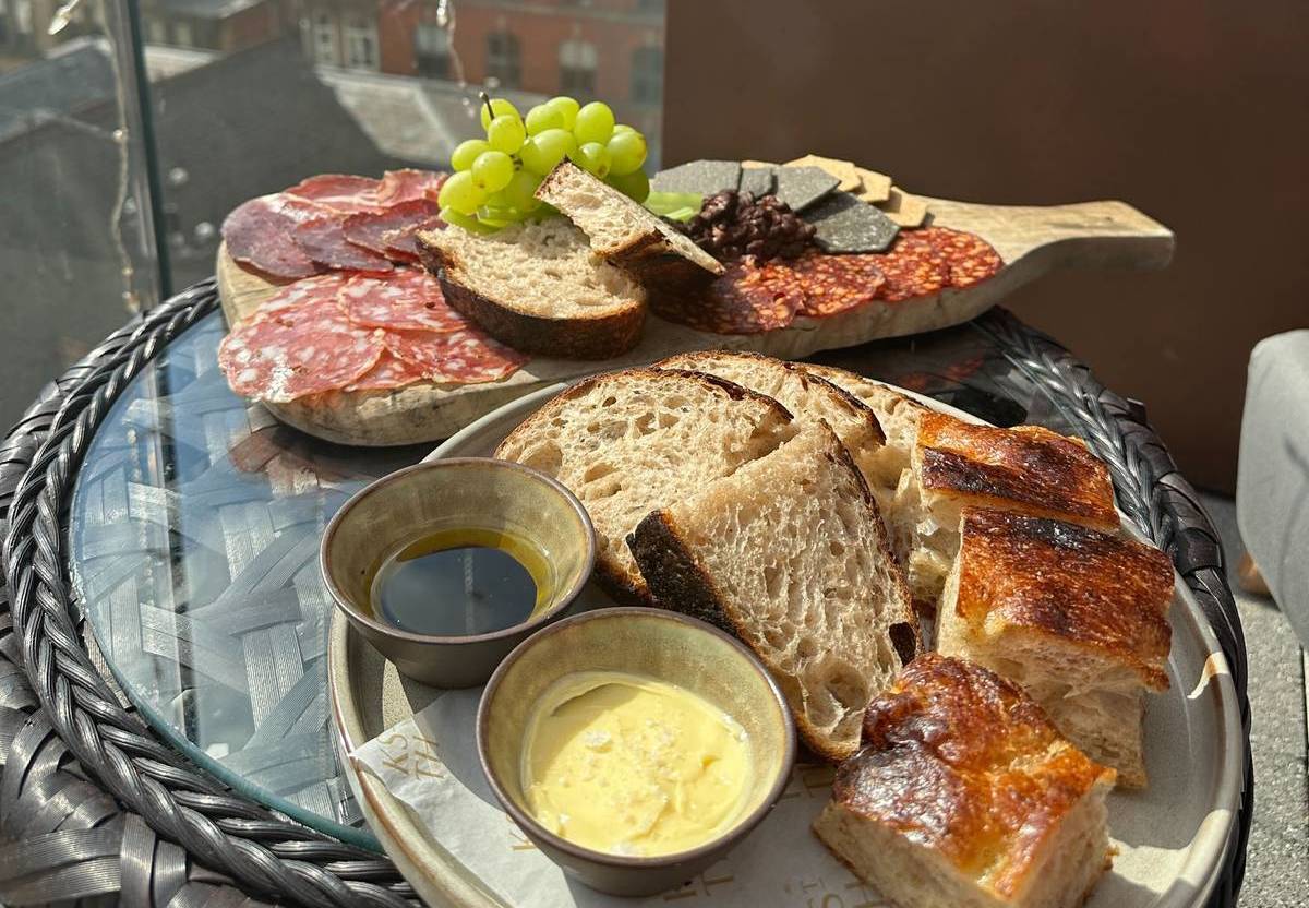 meat grazing board and bread on rooftop terrace at king street townhouse