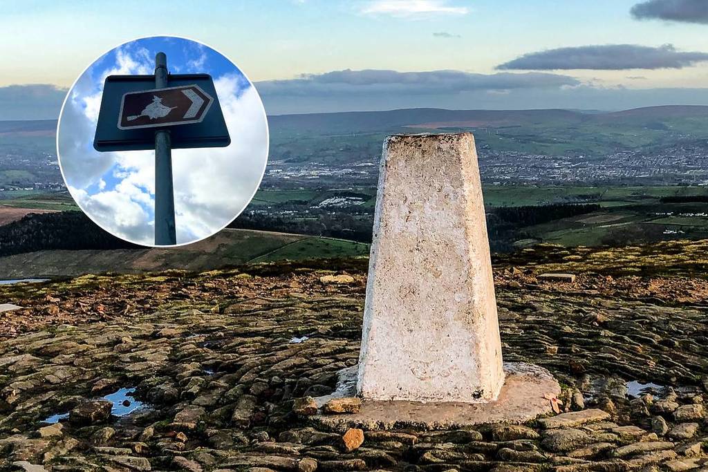 monument on topd of pendle hill with circle of witch sign