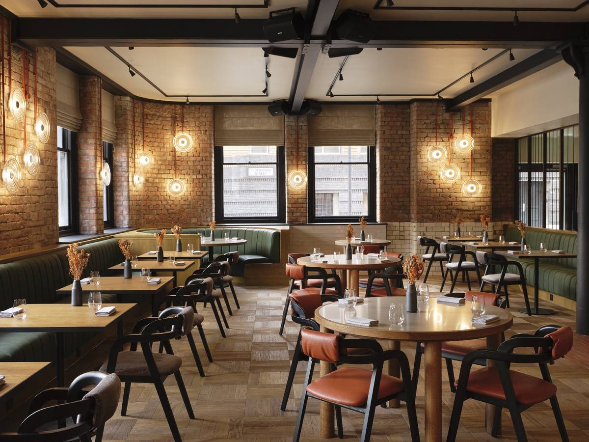 inside skof restaurant in manchester with tables and chairs