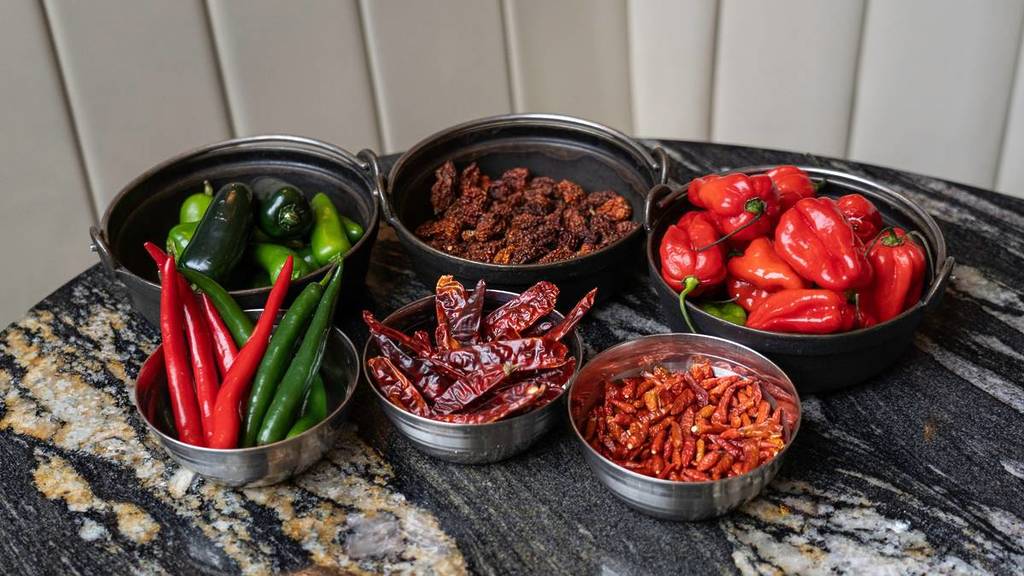 selection of different types of chillis including scotch bonnet, carolina reaper and jalapenos