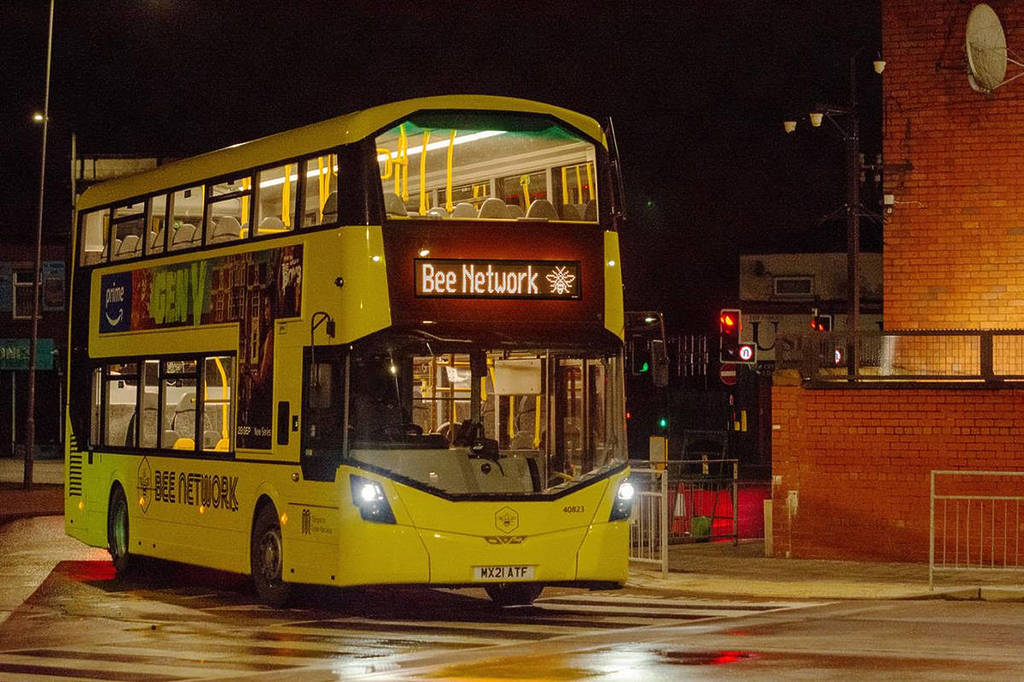 yellow-double-decker-bus-coming-into-bus-station-with-bee-network-on-front-as-part-of-phase-two