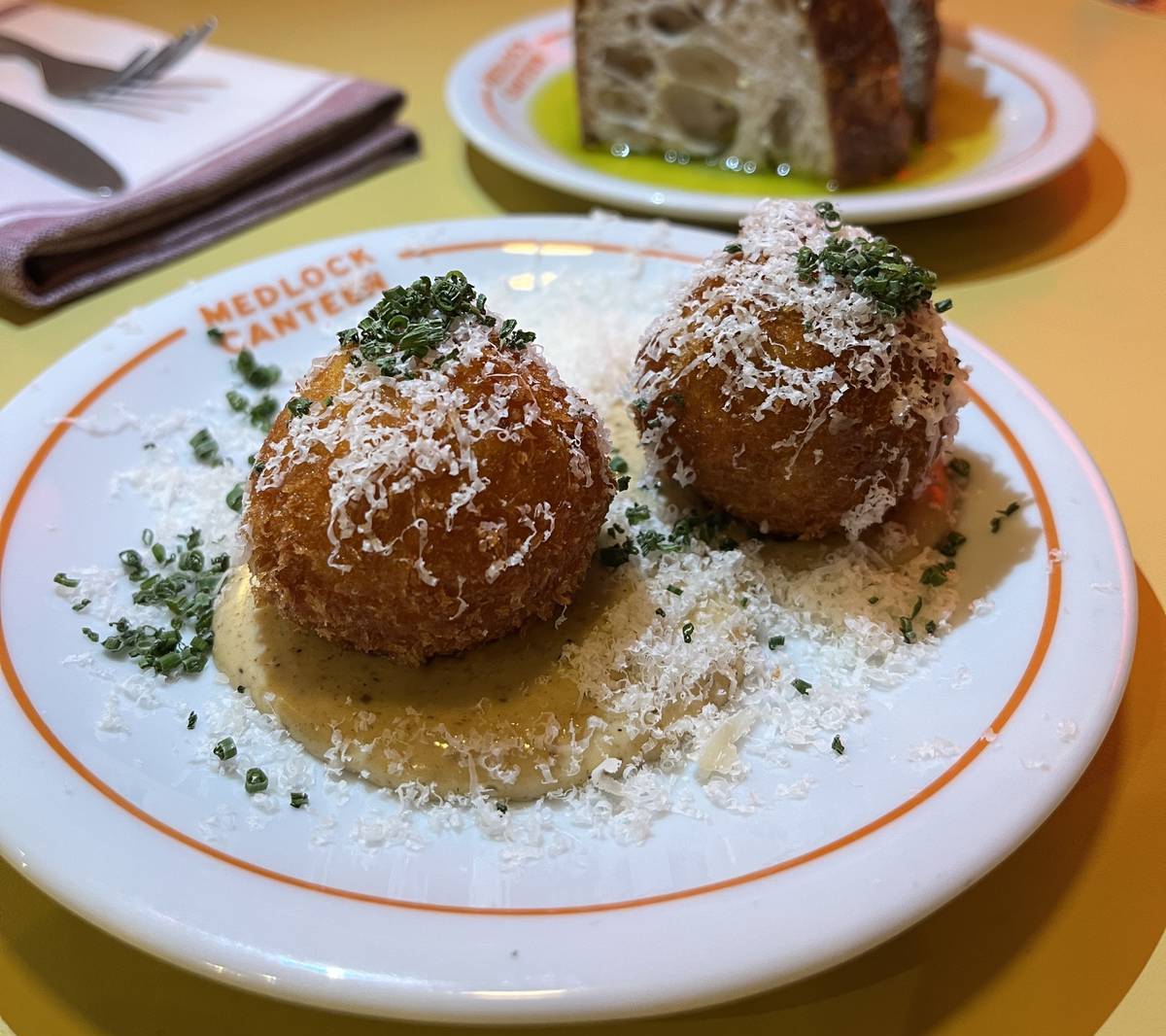 croquettes-with-parmesan-shavings-on-to-and-slice-bread-in-background