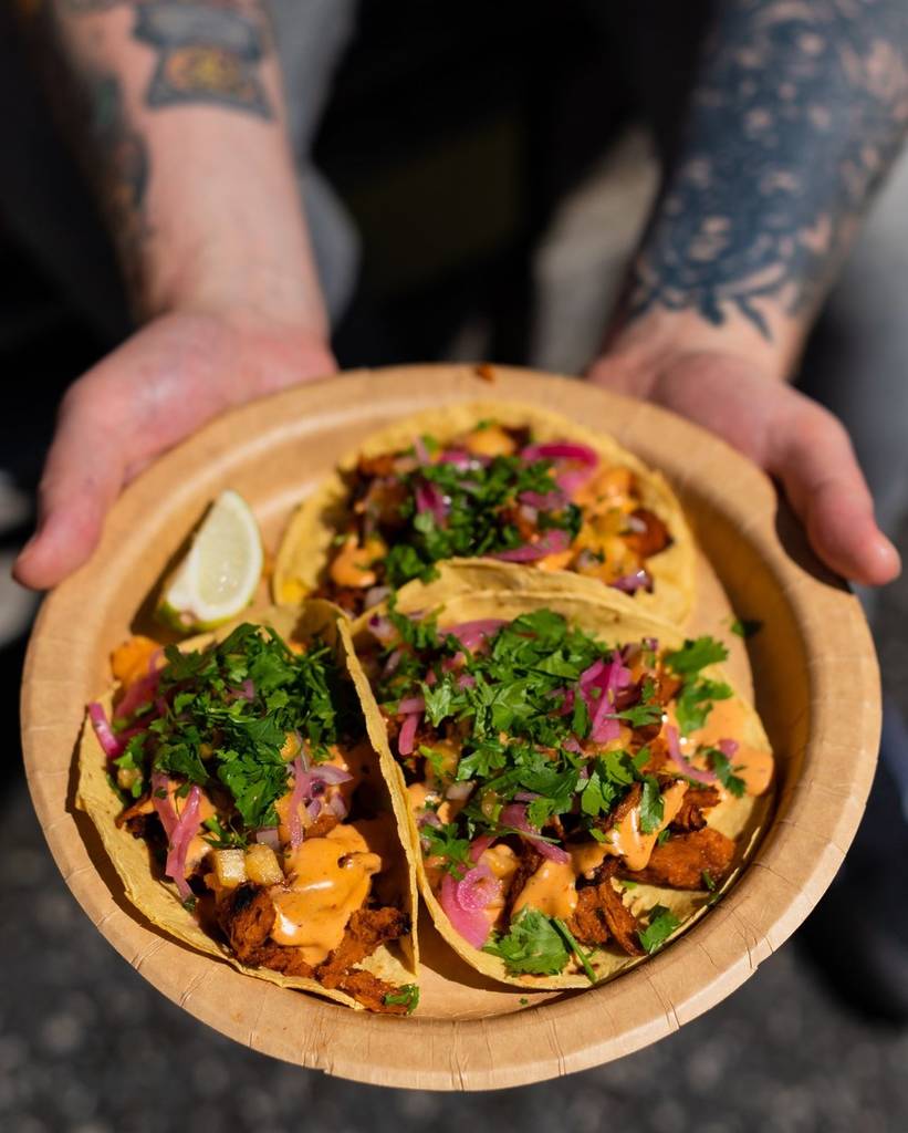 tacos-in-sun-held-out-on-plate