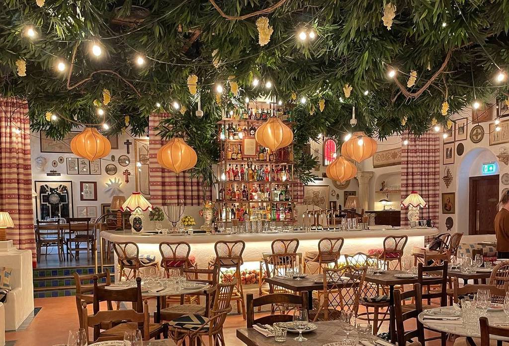 inside circolo popolare big mamma restaurant in manchester with bar area and festoon lights hanging from ceiling