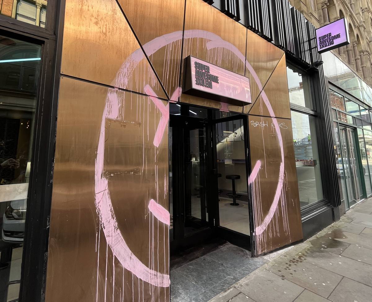 outside former lono cove site with sign saying super awesome deluxe