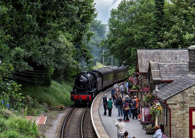 steam train railway coming through haworth
