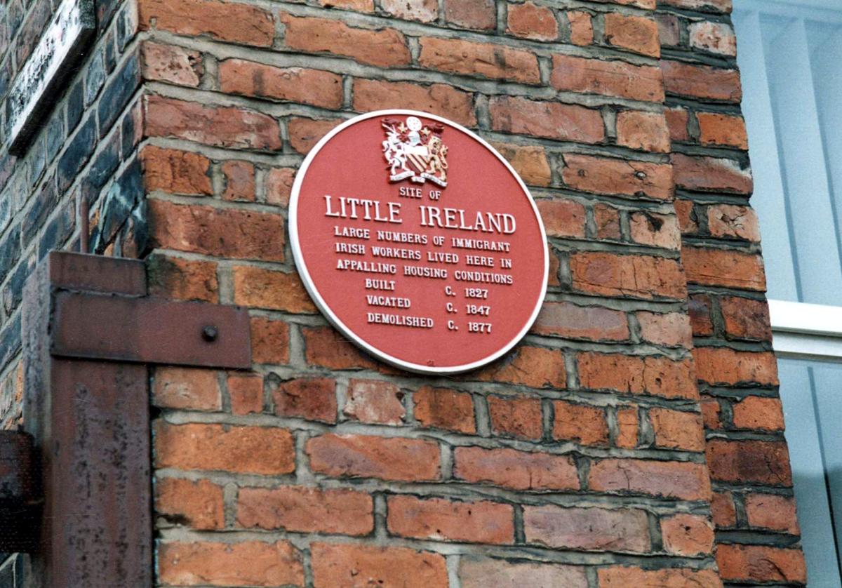 little ireland red plaque on brick wall in manchester