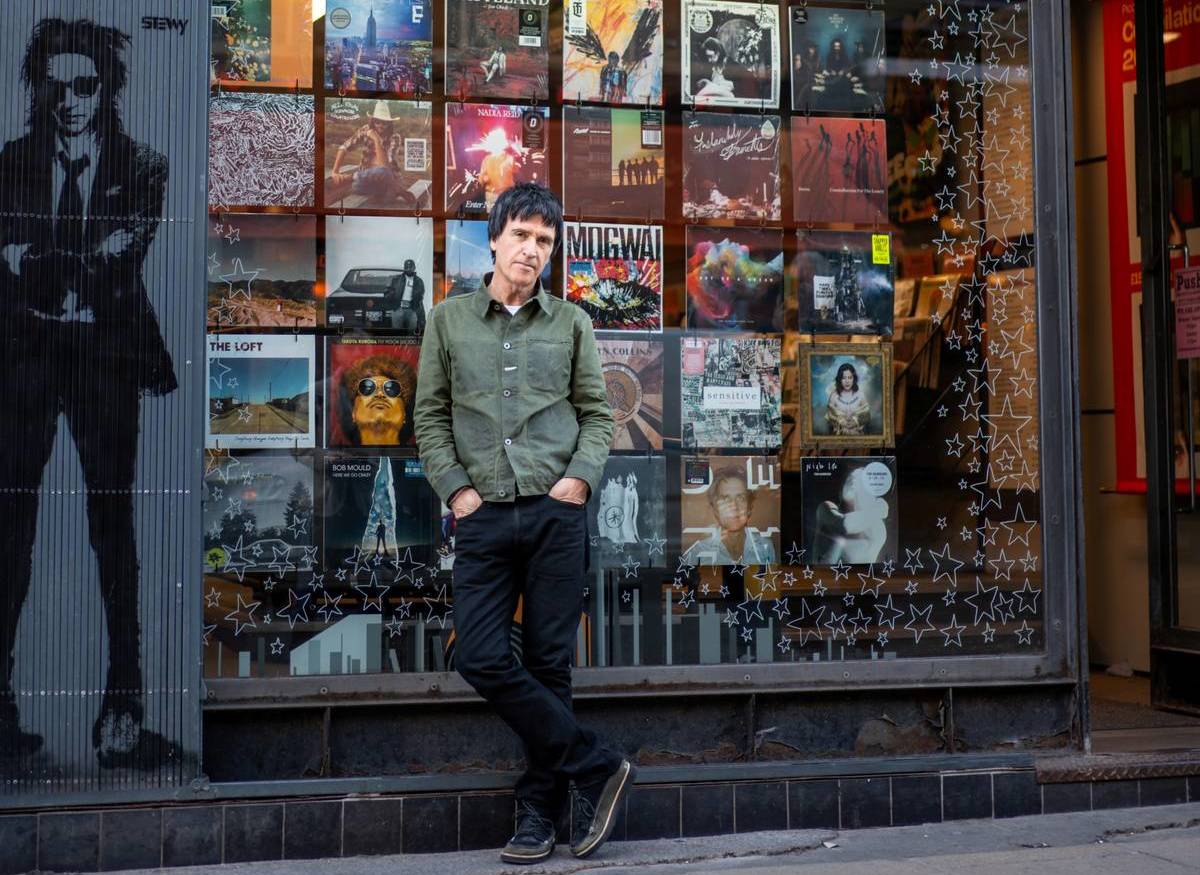 johnny marr stood outside records as named record store legend