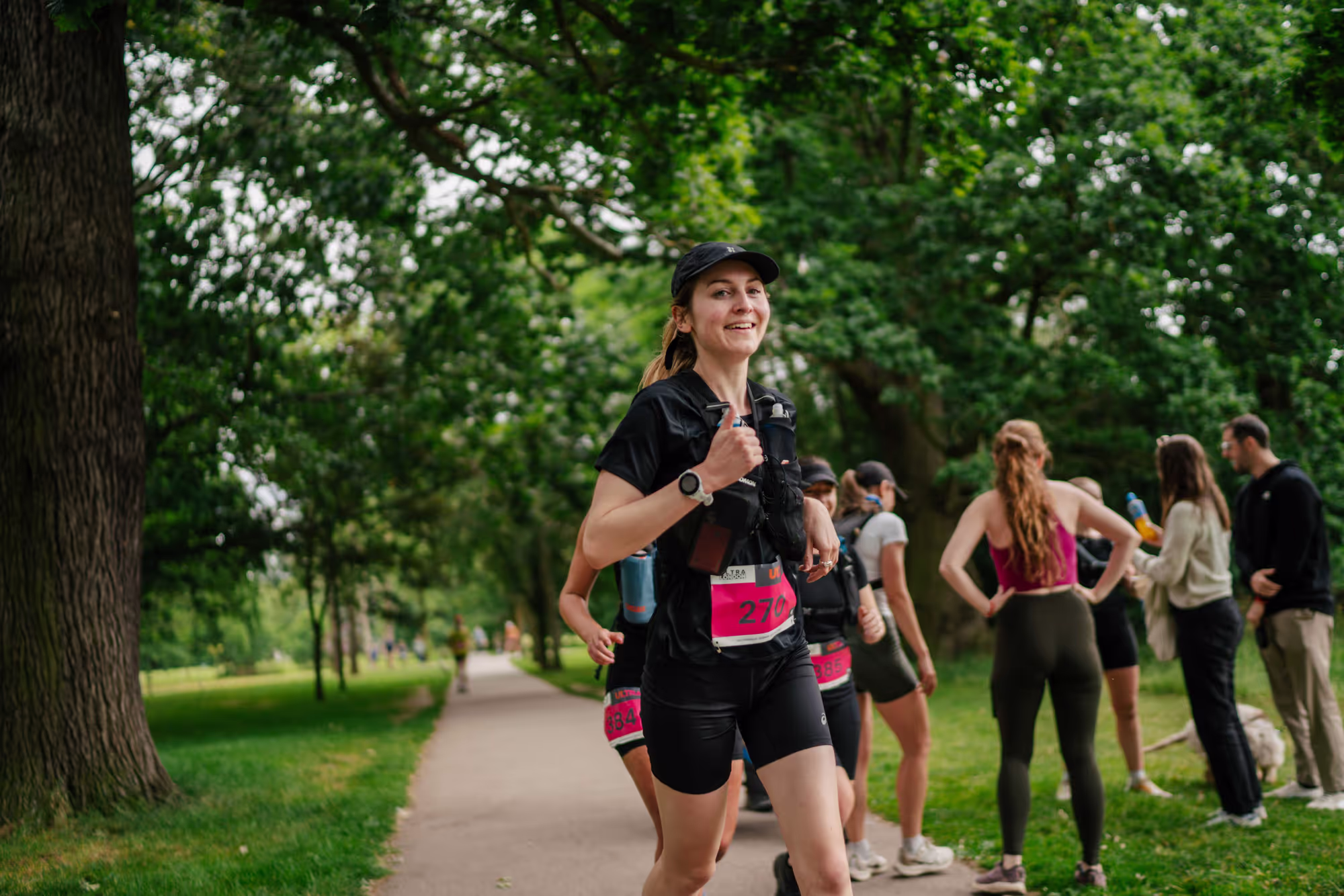 runner smiling in park running ultra marathon beyond manchester