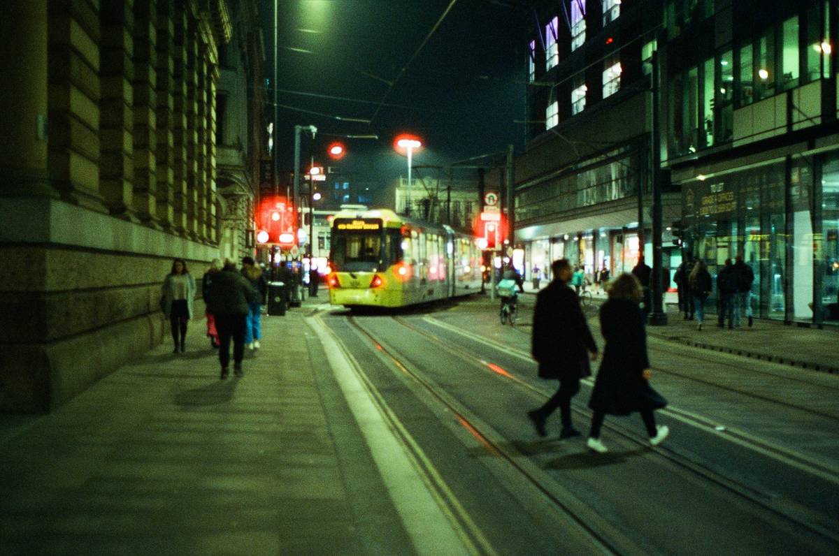 blurry picture of manchester at nightime