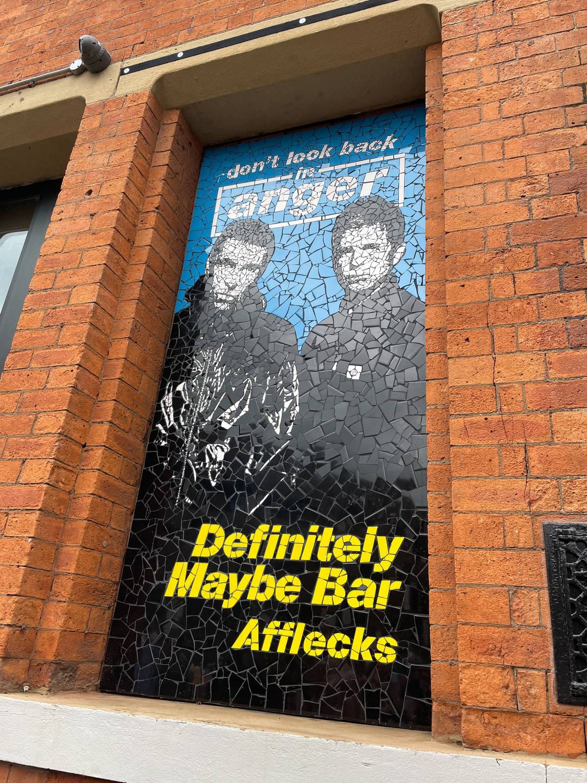 close up of oasis mosaic outside definitely maybe bar at afflecks, manchester