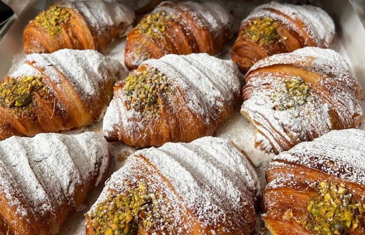 the flat baker cafe brunch croissants on a tray