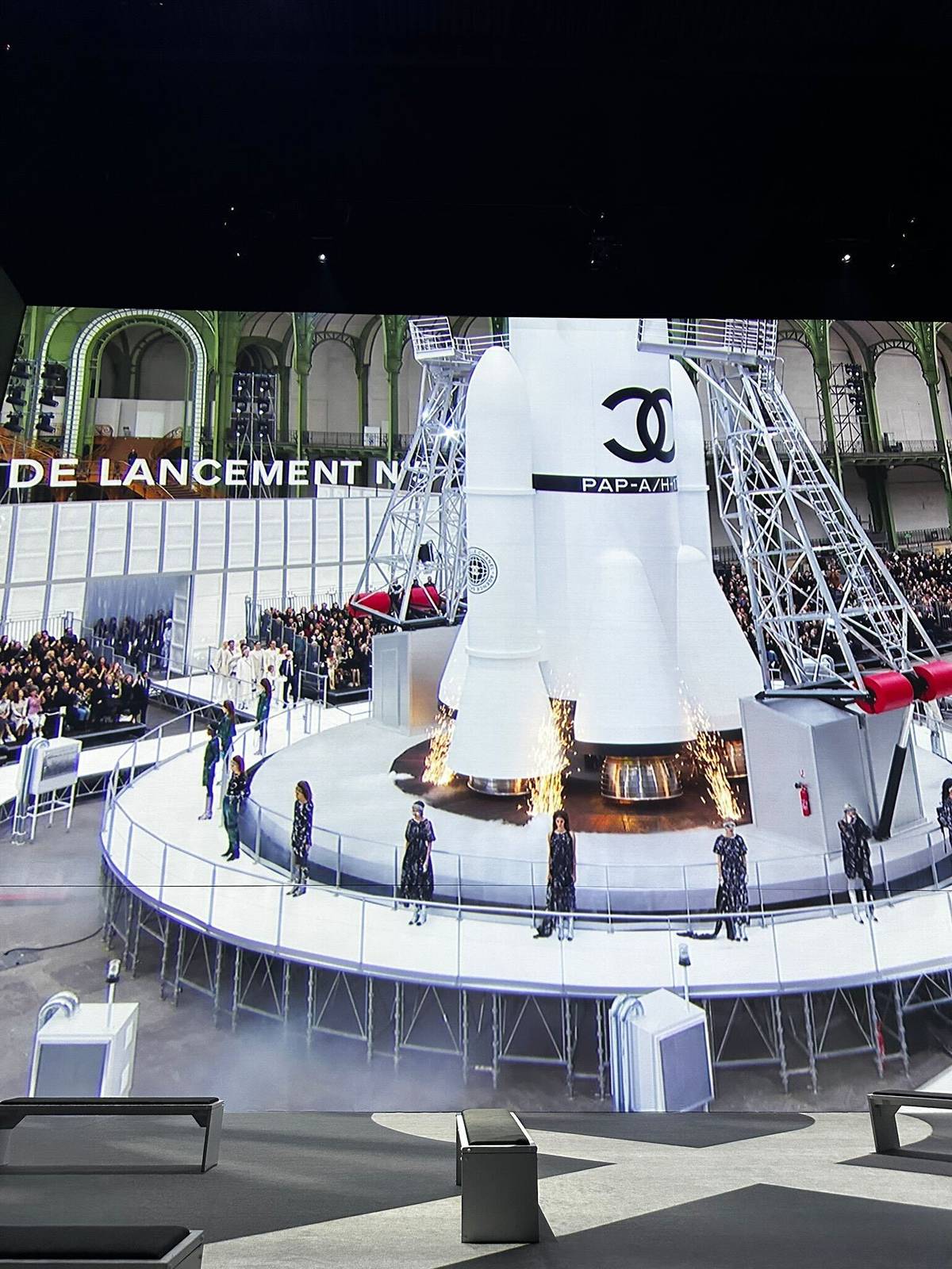 projection of chanel runway show with rocket in centre part of vogue inventing the runway exhibition at factory international in manchester